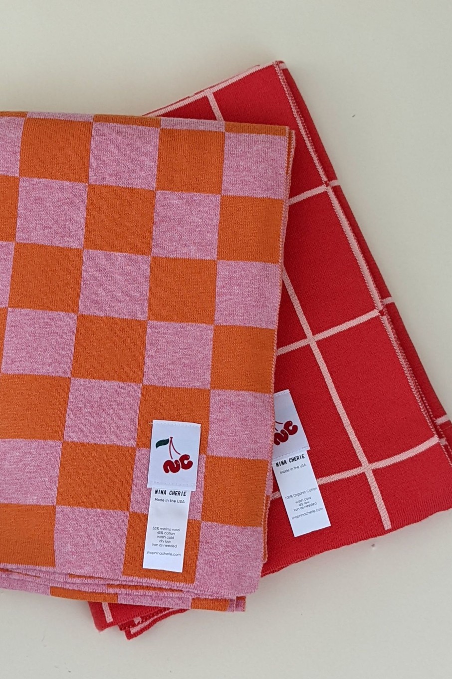 Lifestyle Nina Cherie | Nina Cherie-Contrast Grid Throw Blanket: Orange/ Pink